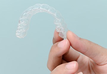 Patient holding clear aligner