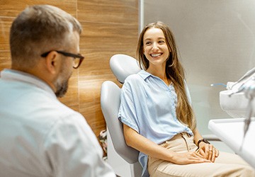 Female patient smiling at dentist at dental appointment