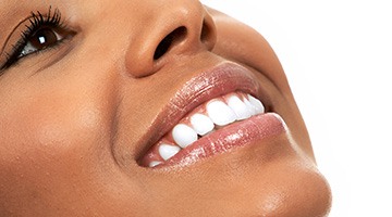 A woman paying the cost of cosmetic dentistry